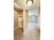 Spacious room with walk-in closet, carpeted floors, a ceiling fan, and a window at 300 W 5Th St # 404, Charlotte, NC 28202