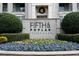 Elegant Fifth and Poplar Condominiums signage surrounded by colorful landscaping at 300 W 5Th St # 404, Charlotte, NC 28202