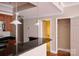 Kitchen view with granite counters, stainless appliances, and open flow to bathroom and closet at 300 W 5Th St # 404, Charlotte, NC 28202
