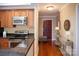 Modern kitchen with stainless steel appliances and granite countertops is adjacent to the front entry hall at 300 W 5Th St # 404, Charlotte, NC 28202