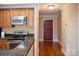 Open kitchen area with granite counters, stainless appliances, and hardwood floors near the entry at 300 W 5Th St # 404, Charlotte, NC 28202