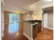 Open-concept living area with hardwood floors, stainless steel appliances and balcony access at 300 W 5Th St # 404, Charlotte, NC 28202