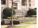 Elegant sign for Fifth & Poplar Condominiums, surrounded by manicured landscaping and greenery at 300 W 5Th St # 404, Charlotte, NC 28202