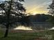 Lake view featuring sunrise, grassy shore, and tree at 3154 Loomis St, Lincolnton, NC 28092