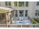 Back deck with comfortable seating, string lights, and views of the lush green landscaping at 3304 Danhill Pl, Matthews, NC 28105