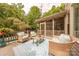 Back deck with comfortable seating, outdoor space, lush landscaping and access to the pool area at 3304 Danhill Pl, Matthews, NC 28105