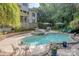 Backyard features a sparkling pool, jacuzzi, lush landscaping and an outdoor dining area perfect for entertaining at 3304 Danhill Pl, Matthews, NC 28105