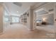 View of bedroom from hallway with built-in bookcase; neutral carpet and paint at 3304 Danhill Pl, Matthews, NC 28105