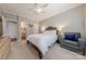 Cozy bedroom with neutral tones, a ceiling fan, ensuite bathroom, and comfortable seating area at 3304 Danhill Pl, Matthews, NC 28105