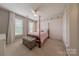 Bedroom featuring a four-poster bed, two windows, and plush carpeting at 3304 Danhill Pl, Matthews, NC 28105