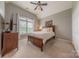 Bedroom with neutral decor, large window and a wood bed frame at 3304 Danhill Pl, Matthews, NC 28105