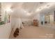 Bright bonus room with sloped ceiling, a play tent and shelving along the wall to store all the toys at 3304 Danhill Pl, Matthews, NC 28105