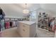 Walk-in closet with center island, lots of shelving, and hanging rods at 3304 Danhill Pl, Matthews, NC 28105