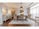 Formal dining room featuring stylish chandelier, neutral colors, and large windows at 3304 Danhill Pl, Matthews, NC 28105