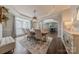 Bright dining room with a large window, elegant rug, and a classic sideboard at 3304 Danhill Pl, Matthews, NC 28105