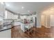 Modern kitchen with stainless appliances, white cabinetry, center island, and bar stool seating for entertaining at 3304 Danhill Pl, Matthews, NC 28105