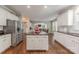 Elegant kitchen features white cabinets, stainless appliances, center island, and open layout for entertaining at 3304 Danhill Pl, Matthews, NC 28105