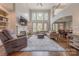 Inviting living room with high ceilings, fireplace, built-in shelving, and large windows at 3304 Danhill Pl, Matthews, NC 28105