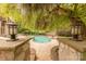 A private backyard oasis with a beautiful pool, mature landscaping, and outdoor seating under a canopy of trees at 3304 Danhill Pl, Matthews, NC 28105