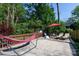 Backyard featuring a hammock, seating area, trees, and a shed at 3307 Draper Ave, Charlotte, NC 28205