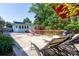 Backyard patio area featuring a hammock, lounge chairs, and a small deck at 3307 Draper Ave, Charlotte, NC 28205