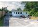 Backyard featuring a concrete patio, deck, basketball hoop, grill, and partial fencing at 3307 Draper Ave, Charlotte, NC 28205