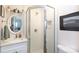 Bathroom featuring white tile, glass enclosed shower and a decorative mirror at 3307 Draper Ave, Charlotte, NC 28205