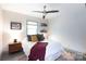 Bedroom featuring large windows, a bed with decorative pillows and a ceiling fan at 3307 Draper Ave, Charlotte, NC 28205