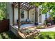 Inviting covered front porch with a pergola, stone accents, and comfortable seating at 3307 Draper Ave, Charlotte, NC 28205