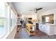 Eat-in kitchen featuring white cabinetry, stainless appliances, and a mobile kitchen island at 3307 Draper Ave, Charlotte, NC 28205
