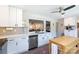 Kitchen view featuring white cabinets, stainless appliances, tile backsplash and a mobile prep island at 3307 Draper Ave, Charlotte, NC 28205