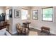 Cozy living room featuring a vintage chair, side table, and ample natural light at 3307 Draper Ave, Charlotte, NC 28205