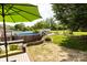 This large backyard features a swimming pool, patio furniture with green umbrella, swing set, and beautiful landscaping at 3310 46Th Ne Ave, Hickory, NC 28601