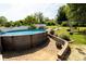 The landscaped backyard features a swimming pool with stone surround, patio, fire pit, and swing set at 3310 46Th Ne Ave, Hickory, NC 28601