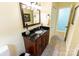 Bathroom featuring dark vanity with granite counter, tile floor, and stylish mirror at 3310 46Th Ne Ave, Hickory, NC 28601