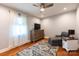 Cozy bedroom features hardwood floors, ceiling fan, and lots of natural light from the large window at 3310 46Th Ne Ave, Hickory, NC 28601