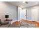 Bedroom showing chair with ottoman, two doors and hardwood floors at 3310 46Th Ne Ave, Hickory, NC 28601