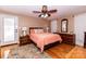 Bright bedroom features hardwood floors, ceiling fan, and stylish furnishings, creating a comfortable and inviting space at 3310 46Th Ne Ave, Hickory, NC 28601