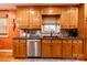 Classic kitchen with wooden cabinets, stainless steel dishwasher, and a tiled backsplash at 3310 46Th Ne Ave, Hickory, NC 28601