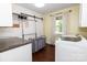 Bright laundry room with modern washer, dryer, shelving, and hanging rack at 3310 46Th Ne Ave, Hickory, NC 28601