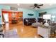 Inviting living room with warm hardwood floors, a plush brown leather sectional, and connecting dining area at 3310 46Th Ne Ave, Hickory, NC 28601
