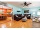 Inviting living room with warm hardwood floors, a plush brown leather sectional, and connecting dining area at 3310 46Th Ne Ave, Hickory, NC 28601