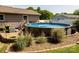 Above ground swimming pool is surrounded by landscaping, with a wooden deck and stairs leading up to it at 3310 46Th Ne Ave, Hickory, NC 28601