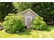 A garden shed is surrounded by greenery, providing ample storage space for tools and equipment at 3310 46Th Ne Ave, Hickory, NC 28601
