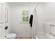 Bright bathroom featuring a shower/tub combo and a window for natural light at 3424 Clydesdale Dr, Gastonia, NC 28056