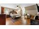 Comfortable bedroom with hardwood floors, neutral walls, a ceiling fan, and cozy seating area at 3424 Clydesdale Dr, Gastonia, NC 28056