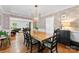Elegant dining room with hardwood floors, decorative wallpaper, and a stylish light fixture at 3424 Clydesdale Dr, Gastonia, NC 28056