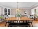 Bright dining room featuring hardwood floors, modern light fixture, and adjacent living space at 3424 Clydesdale Dr, Gastonia, NC 28056