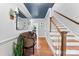 Inviting foyer featuring hardwood floors, stylish bench, staircase, and blue painted ceiling at 3424 Clydesdale Dr, Gastonia, NC 28056