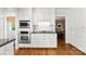 Well-maintained kitchen featuring white cabinets, stainless steel appliances, and hardwood flooring at 3424 Clydesdale Dr, Gastonia, NC 28056